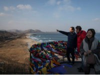 people-look-out-korea-demilitarized-zone-dmz-getty In a photo taken on February 11, 2018, a family pose for photos at an observation deck overlooking the Demilitarized Zone (DMZ) and coastline of North Korea, at the Goseong Unification Observatory on South Korea's northeast coast. Despite the sudden thaw in ties with diplomatic visits during the Pyeongchang 2018 …