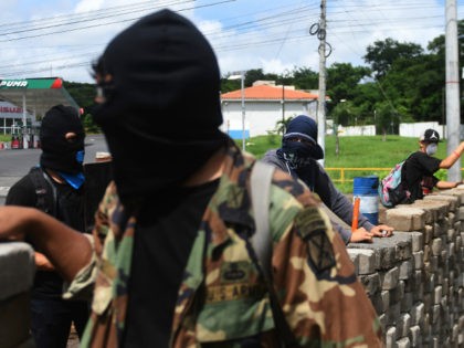 Students with homemade mortars remain at a barricade in the face of ongoing attacks from r