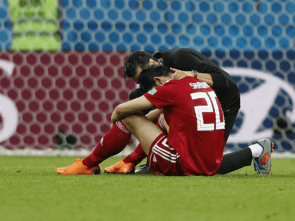 Iran's Sardar Azmoun is consoled at the end of the group B match between Iran and Spain at the 2018 soccer World Cup in the Kazan Arena in Kazan, Russia, Wednesday, June 20, 2018. Spain won 1-0. (AP Photo/Frank Augstein)