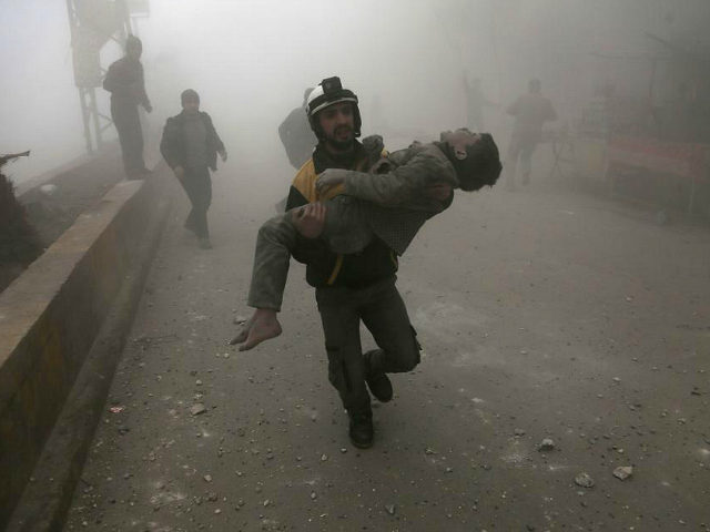 TOPSHOT - EDITORS NOTE: Graphic content / A volunteer from the Syrian Civil Defence (known