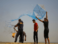 terror kite gaza Palestinian protestors prepare to fly a kite loaded with an incendiary during a demonstration along the border with Israel east of Jabalia in the central Gaza Strip on June 8, 2018. - Palestinians in the besieged coastal enclave have used kites carrying burning cans to set ablaze Israeli fields, torching …