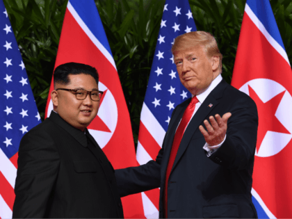US President Donald Trump (R) gestures as he meets with North Korea's leader Kim Jong Un (L) at the start of their historic US-North Korea summit, at the Capella Hotel on Sentosa island in Singapore on June 12, 2018. - Donald Trump and Kim Jong Un have become on June …