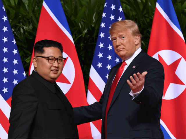 US President Donald Trump (R) gestures as he meets with North Korea's leader Kim Jong Un (L) at the start of their historic US-North Korea summit, at the Capella Hotel on Sentosa island in Singapore on June 12, 2018. - Donald Trump and Kim Jong Un have become on June …