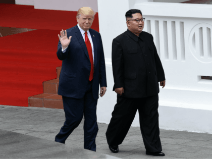 North Korea's leader Kim Jong Un (R) walks with US President Donald Trump (L) after lunch and during a break in talks at their historic US-North Korea summit, at the Capella Hotel on Sentosa island in Singapore on June 12, 2018. - Donald Trump and Kim Jong Un became on …