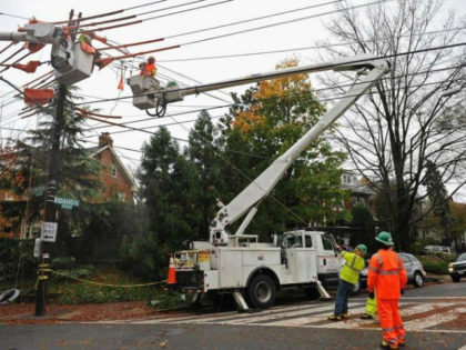 A Pepco crew repairing power lines in Washington. The company said it will cut customers’ rates because of its savings from the new tax law.