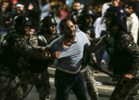 Members of the Jordanian gendarmerie detain a protester during a demonstration outside the Prime Minister's office in the capital Amman late on June 2, 2018 Members of the Jordanian gendarmerie detain a protester during a demonstration outside the Prime Minister's office in the capital Amman late on June 2, 2018