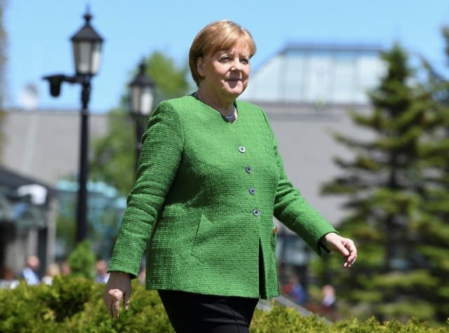 Merkel open to EU migration reform, cautious on eurozone