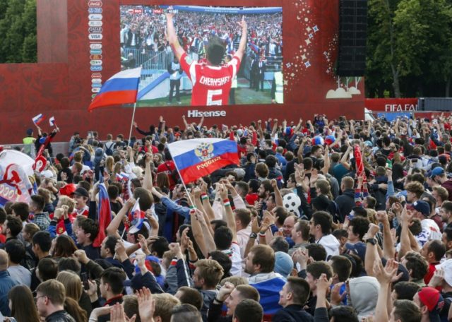 Flag-waving fans party as Russia wins World Cup opener in Moscow