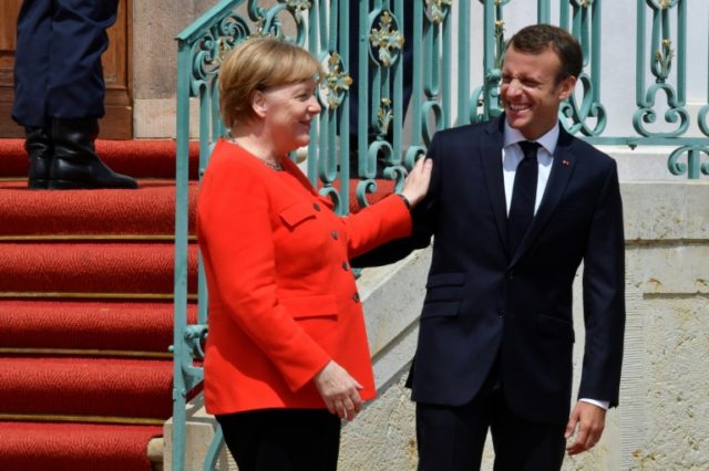 Macron backs EU partner Merkel in immigration crisis