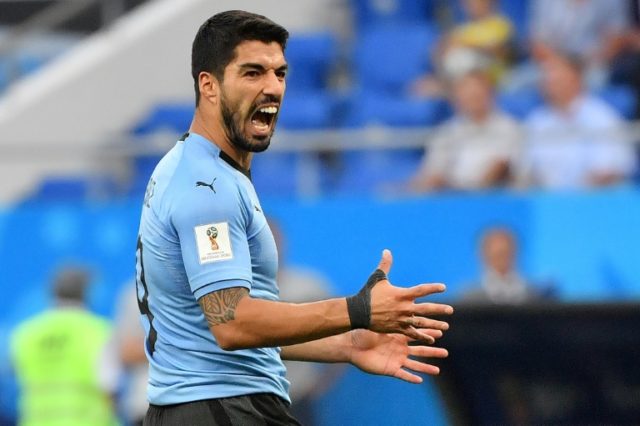 Uruguay, Russia reach World Cup knockout phase