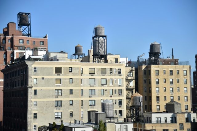 On NY's rooftops, old-style wooden water tanks hang tough