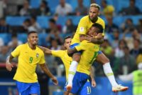 Brazil's midfielder Paulinho (R) celebrates with teammates Brazil's forward Neymar (top), Brazil's forward Gabriel Jesus (L) and Brazil's forward Philippe Coutinho after scoring during the Russia 2018 World Cup Group E football match between Serbia and Brazil at the Spartak Stadium in Moscow on June 27, 2018.