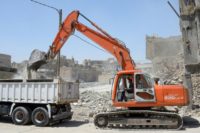 An excavator clears rubble in Mosul as Iraq begins a clean-up operation nearly a year after the Islamic State group was expelled from the city