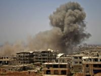 Smoke rises above opposition held areas of the city of Daraa during air strikes by Syrian regime forces on June 28, 2018