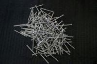 A pile of nails is seen on a table at the Mid Continent Nail Corporation in Poplar Bluff, Missouri