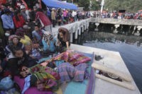 Hundreds pray at Indonesia lake as search for bodies resumes