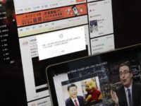 A screen shows a failure message saying a post could not be sent because "the content contains information that violates relevant laws and regulations" on Sina Weibo next to a smaller computer screen showing a "Last Week Tonight" HBO show's host John Oliver with a photo of Chinese President Xi Jinping and Winnie the Pooh, in Beijing, Friday, June 22, 2018. The popular Chinese social media site is blocking users from posting about the show and its HBO host Oliver after the news satire program aired a segment this week making fun of Xi. (AP Photo/Andy Wong) The Associated Press