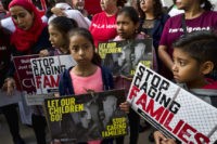 Immigration Separating Families Children stand and hold protest signs during a rally in front of Federal Courthouse in Los Angeles on Tuesday, June 26, 2018. Immigrant rights advocates asked a federal judge to order the release of parents separated from their children at the border, as demonstrators decrying the Trump administration's immigration crackdown were arrested Tuesday at a rally ahead of a Los Angeles appearance by Attorney General Jeff Sessions. (AP Photo/Richard Vogel) The Associated Press