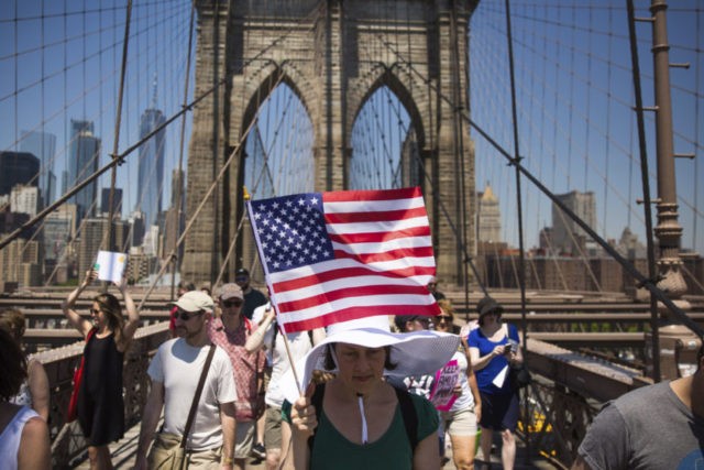 APTOPIX Immigration Protests Activists carry signs across the Brooklyn Bridge during a rally to protest the Trump administration's immigration policies Saturday, June 30, 2018, in New York, New York. (AP Photo/Kevin Hagen) The Associated Press