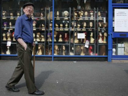 a man walking past a London wig shop