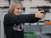 woman-holds-handgun-purchase-shop-file-getty *** EXCLUSIVE - VIDEO AVAILABLE *** ORLANDO, FLORIDA - DECEMBER 11: NRA certified instructor and founder of the Florida faction of Pink Pistols Jo Martin pointing a gun, on December 11, 2016 in Orlando, Florida. A gun group are encouraging members of the gay community to take up arms after …
