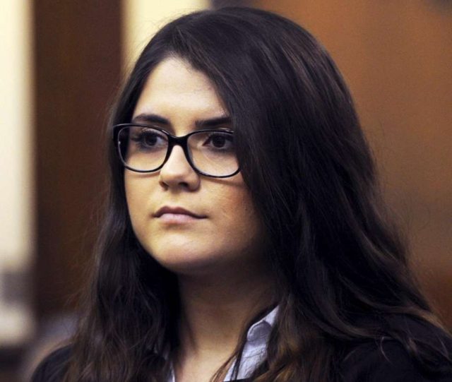 In this March 3, 2017 photo, Nikki Yovino is arraigned in Bridgeport Superior Court, in Bridgeport, Conn. Yovino, a former Connecticut university student accused of lying about being raped by two university football players, is seeking to have the charges against her dismissed. The Connecticut Post reports Yovino filed an …