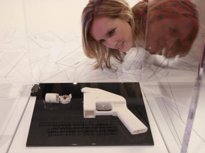 A woman admires a 3D printed handgun which was created and fired by Finnish journalist Ville Vaarne and which is displayed in the exhibition '3D: printing the future' in the Science Museum on October 8, 2013 in London, England. The exhibition, which opens to the public tomorrow, features over 600 …
