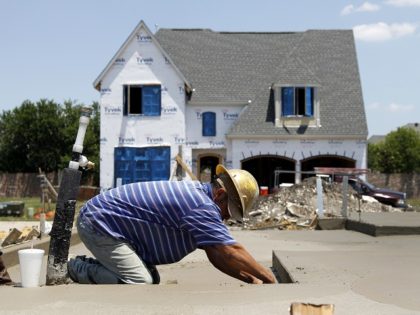A Hawkins-Welwood Homes employee applies the final touches to a foundation as construction on a luxury townhome is shown at rear Wednesday, May 16, 2012, in Plano, Texas. A measure of future U.S. economic activity fell in April, the first setback after six months of increases, reflecting weakness in housing …