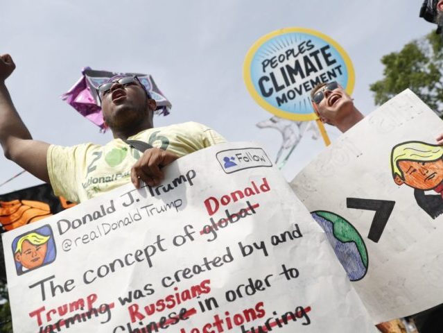 A pair of participants chant in front of the White House in Washington, Saturday, April 29