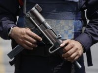 Mexico Violence In this July 17, 2017 file photo, a federal police officer stands guard outside the hangar of the attorney general's office at the Mexico City airport. Mexican officials said Tuesday, Jan. 30, 2018, they are dispatching 5,000 additional federal police to several tourist cities after a series of violent incidents, …