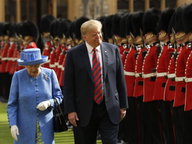 U.S. President Donald Trump and Britain's Queen Elizabeth II inspect a Guard of Honour, formed of the Coldstream Guards at Windsor Castle in Windsor, England, Friday, July 13, 2018.(AP Photo/Matt Dunham, Pool)