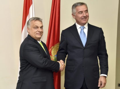 Montenegro President Milo Djukanovic, right, shakes hands with Hungary's Prime Minister Viktor Orban in Montenegro's capital Podgorica, Monday, July 23, 2018. Orban arrived on a two-day visit to Montenegro. (AP Photo/Risto Bozovic)