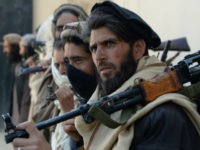Afghan alleged former Taliban fighters carry their weapons before handing them over as part of a government peace and reconciliation process at a ceremony in Jalalabad on February 24, 2016. More than a dozen former Taliban fighters from Nazyan district of Nangarhar province handed over their weapons as part of …