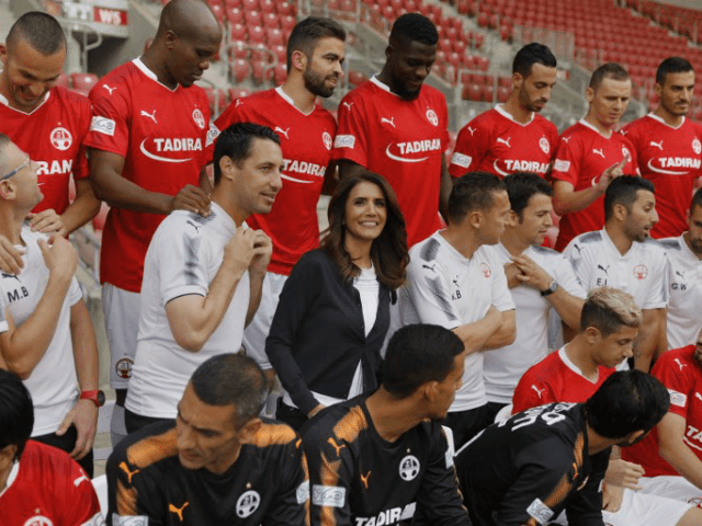 Alona Barkat, the owner of the soccer team Hapoel Beersheba, is seen among players during