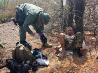 Border Patrol Agent helps migrant suffering from heat - AP Photo - Astrid Galvan Border Patrol agent assists migrant suffering from dehydration in desert. (AP File Photo: Astrid Galvan)