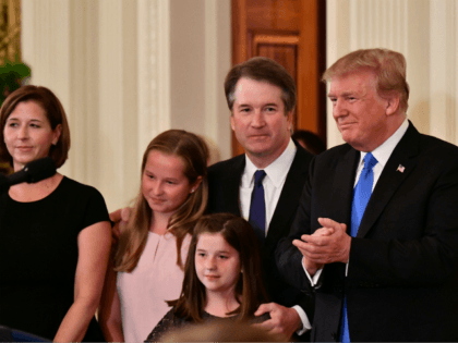 Supreme Court nominee Brett Kavanaugh, his wife Ashley Estes Kavanaugh and their two daughters stand by US President Donald Trump after he announced his nomination in the East Room of the White House on July 9, 2018 in Washington, DC. (Photo by MANDEL NGAN / AFP) (Photo credit should read …