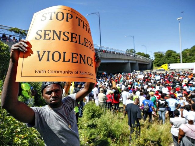 Activists block major freeway to protest gun violence in Chicago An activist holds a sign