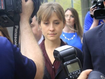 Actress Allison Mack, center, leaves after a hearing at Brooklyn Federal Court, Friday May 4, 2018, in New York. The former "Smallville" actress and Keith Raniere, the leader of the self-help group NXIVM are charged with coercing women who joined the organization, into becoming a part of a secret sub-group …