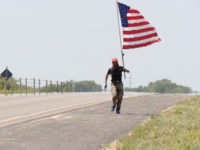 Elliot-Timms-running-MAGA-screenshot A Missouri veteran, Elliot Timms, donning a “Make America Great Again” hat and brandishing an American flag, has been running 15 miles nearly every day for a year hoping to show everyone how much he loves his country.