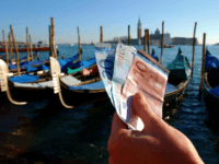 Euros italy 399185 03: A handful of new Euro notes are held in front of a row of Gondolas January 3, 2002 in Venice, Italy. The Euro went into effect on January 1, 2002 in 12 European countries. (Photo By Justin Sullivan/Getty Images)