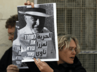 Ezra Nawi Israeli left wing activists hold posters on January 18, 2016 outside a courthouse in Jerusalem during a demonstration to ask for the release of Ezra Nawi, a Jewish man suspected of informing on Palestinians selling property to settlers, a week after he was arrested. Israeli media said Ezra Nawi was …
