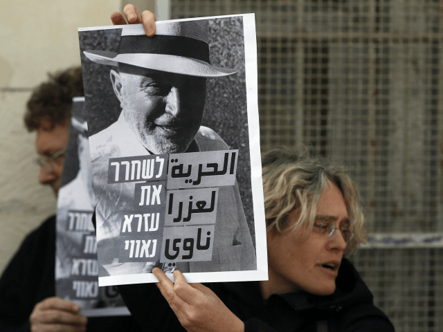 Israeli left wing activists hold posters on January 18, 2016 outside a courthouse in Jerus