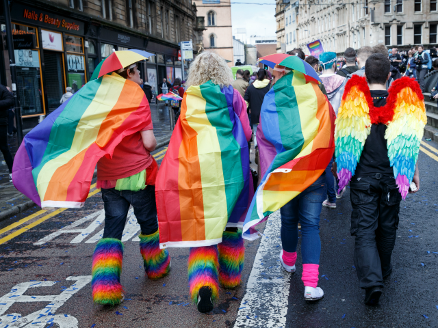 GLASGOW, SCOTLAND - AUGUST 19: Participants wear rainbow flags and angel winfs during the