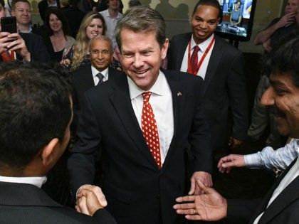 FILE - In this May 22, 2018 file photo, Georgia Secretary of State Brian Kemp, Republican primary candidate for governor celebrates with supporters after giving a speech expecting a runoff with Casey Cagle during an election night results party in Athens, Ga. With a secret recording, allegations of political corruption …