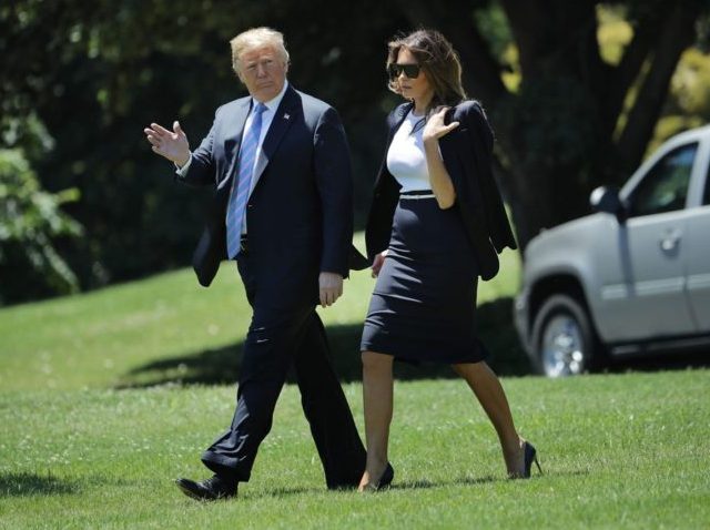 WASHINGTON, DC - JULY 18: U.S. President Donald Trump and first lady Melania Trump walk across the South Lawn as they departs the White House July 18, 2018 in Washington, DC. The Trumps are traveling to Joint Base Andrews to pay their respects to the family of United States Secret …