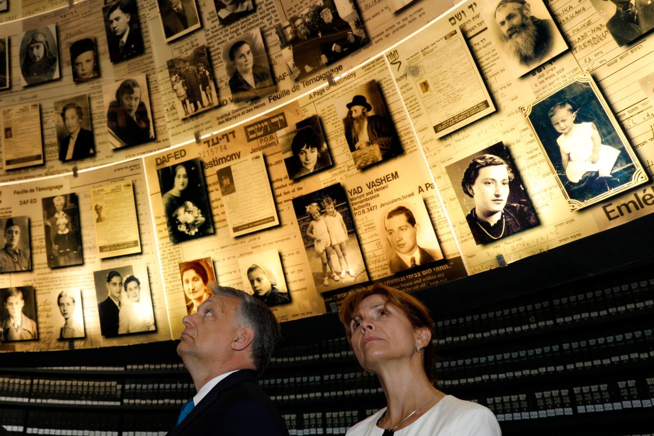Hungarian Prime Minister Viktor Orban and his wife Aniko Levai (R) look at pictures of Jewish Holocaust victims at the Hall of Names on July 19, 2018 during his visit to the Yad Vashem Holocaust Memorial museum in Jerusalem commemorating the six million Jews killed by the German Nazis and their collaborators during World War II. - Hungarian Prime Minister Viktor Orban pledged "zero tolerance" for anti-Semitism on July 19 during a controversial visit to Israel after facing accusations of stoking anti-Jewish sentiment back home. (Photo by GALI TIBBON / AFP) (Photo credit should read GALI TIBBON/AFP/Getty Images)