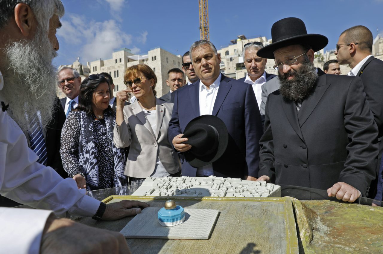 Hungarian Prime Minister Viktor Orban (C) flanked by his wife (L) and Rabbi of the Western Wall Shmuel Rabinovitch (R) listens to historical account of Jerusalem's Temple Mount during his visit to Israel on July 20, 2018. - The Hungarian Prime Minister pledged "zero tolerance" for anti-Semitism on July 19, 2018, during a controversial visit to Israel after facing accusations of stoking anti-Jewish sentiment back home.Orban and Israeli Prime Minister Benjamin Netanyahu have found common cause in their right-wing views despite controversy surrounding the Hungarian leader's nationalist rhetoric. (Photo by MENAHEM KAHANA / AFP) (Photo credit should read MENAHEM KAHANA/AFP/Getty Images)