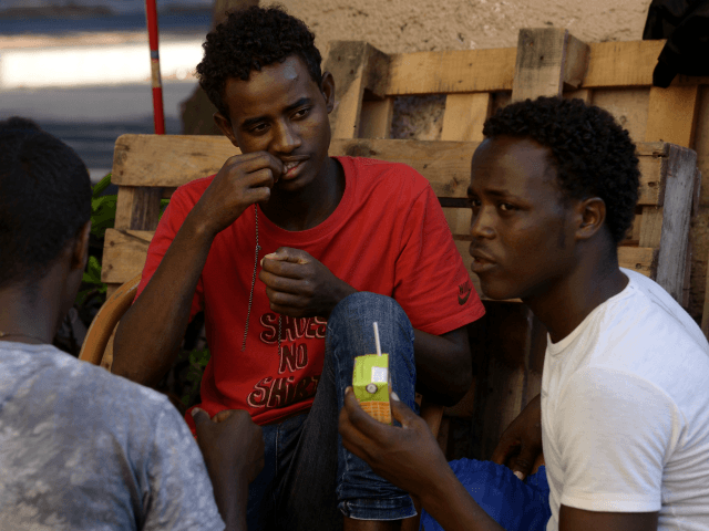 Migrants sit in the street of Via Cupa outside the former Baobab migrants reception centre next to the Tiburtina train station in Rome on August 8, 2016. Set up almost three years ago the Baobab centre was shut down by police in December 2015 in the wake of Paris attacks. …