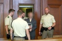 Wolfgang P, member of the far-right movement "Citizens of the Reich" (Reichsbuerger), arrives at his trial at the Nuremberg-Fuerth Court in Nuremberg, southern Germany on August 29, 2017. The man belonging to the far-right movement, which rejects the legitimacy of the modern German state, is accused of shooting dead a …