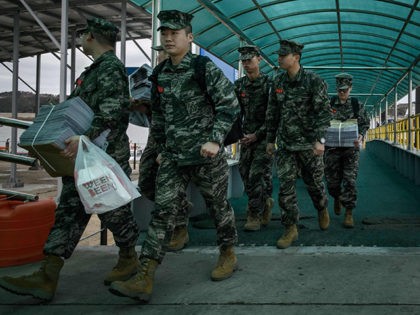 In a photo taken on April 24, 2018 South Korean soldiers disembark from a passenger ferry at Yeonpyeong island, near the 'northern limit line' sea boundary with North Korea. (Photo by Ed JONES / AFP) / To go with SKorea-NKorea-diplomacy-politics-attack, Focus by Sunghee Hwang (Photo credit should read ED JONES/AFP/Getty …